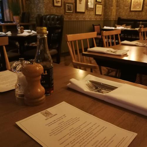 a bottle of wine on a table in a restaurant at The Red Lion Hawkshaw in Bury