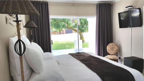 Ένα ή περισσότερα κρεβάτια σε δωμάτιο στο Gouritz Guesthouse