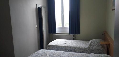 a small room with two beds and a window at hotel Melissa in Péruwelz