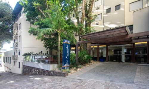 a building with a sign on the side of it at A Furninha Hotel in Torres