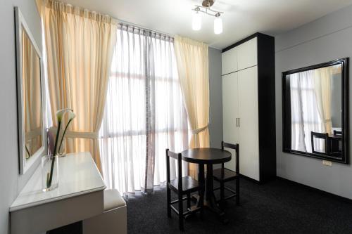 a room with a table and a mirror and a window at Costa Del Inka Hotel in Urbanizacion Buenos Aires