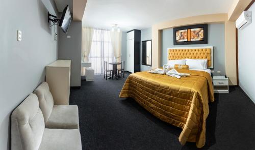 a hotel room with a bed and a chair at Costa Del Inka Hotel in Urbanizacion Buenos Aires
