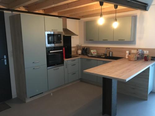 a kitchen with a wooden counter top in a room at Gîte PLACE FOR YOU in Malissard