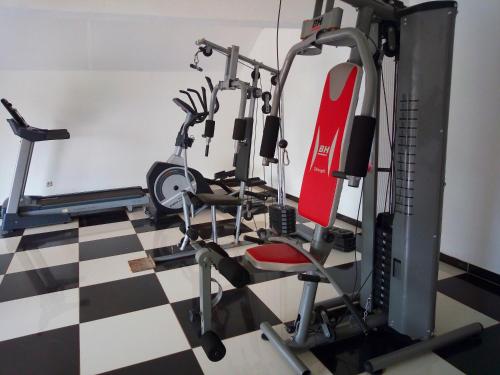 a gym with several tread machines on a checkered floor at La Résidence d'Ankerana in Antananarivo