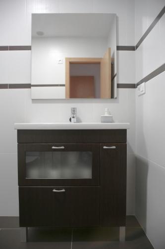 a bathroom with a sink and a mirror at Natura Apartments in Chelva