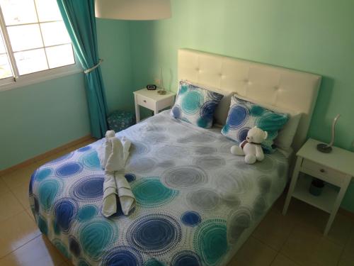 a bedroom with a bed with a teddy bear on it at Laderas del Palmar in Palm-Mar