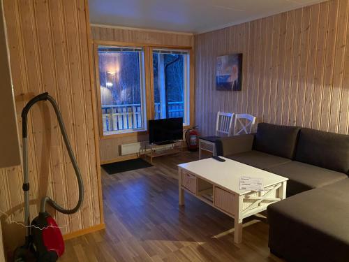 a living room with a couch and a table at IMA Tursenter in Oteren