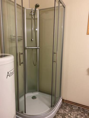 a shower with a glass door in a bathroom at IMA Tursenter in Oteren