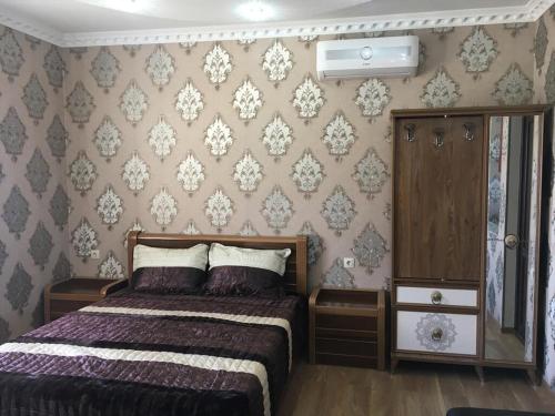 a bedroom with a bed and a wall at Gricko in Tbilisi City