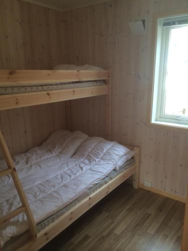 a bedroom with two bunk beds and a window at IMA Tursenter in Oteren