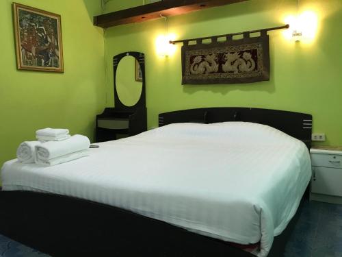 a bedroom with a large white bed and a mirror at Swan inn 2 Nana in Bangkok