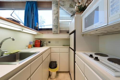 a small kitchen with a sink and a stove at Boat Accommodations Barcelona in Barcelona