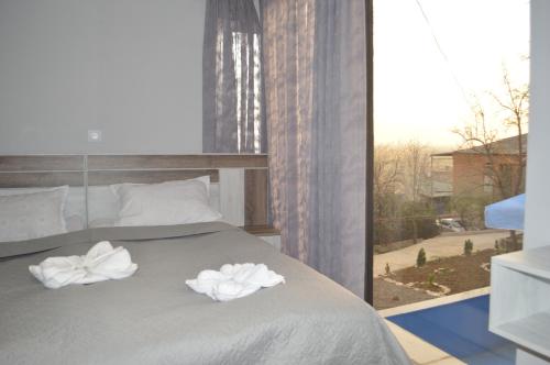 a bedroom with a bed with two towels on it at hill-fort kutaisi in Kutaisi