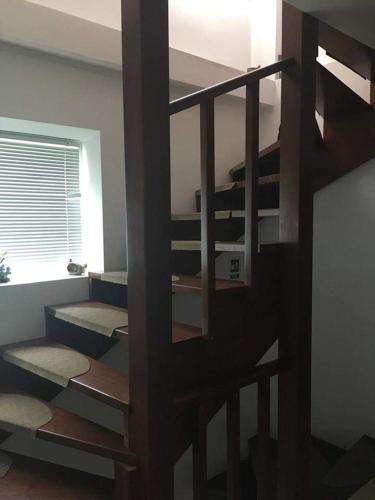 a spiral staircase in a room with a window at Vila Denis in Costinesti