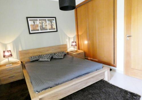 En eller flere senge i et værelse på Apartamento Vista Golfe Mar Vilamoura
