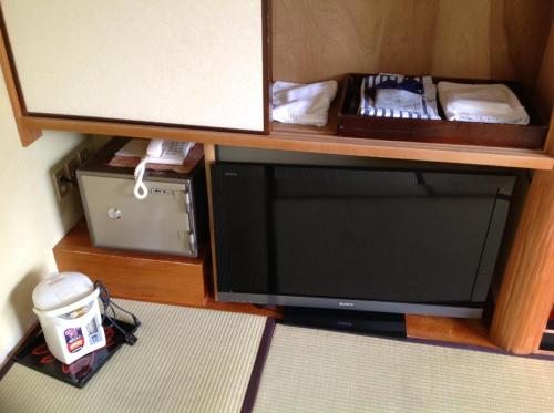 a flat screen tv sitting on top of a table at Chikurinin Gunpoen in Yoshino