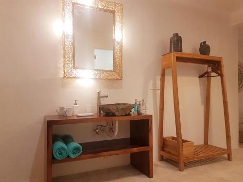 a bathroom with a sink and a mirror at Amaite Holbox - Oceanfront Hotel in Holbox Island
