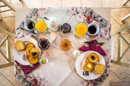a table with two plates of food and two cups of coffee at Naiades Guesthouse in Klávsion
