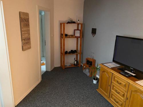a living room with a flat screen tv on a dresser at Penzión Exclusive in Trenčín