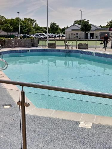 a large blue swimming pool in a parking lot at lakeland leisure park in Flookburgh