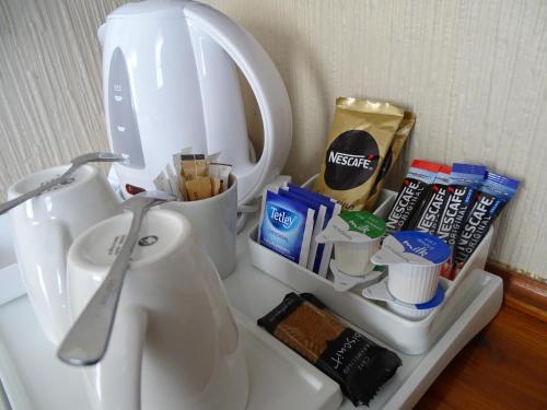 a kitchen counter with a white sink with a mixer at The Lansdowne in Leamington Spa