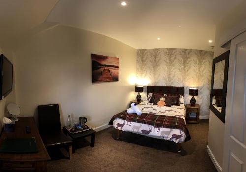 a bedroom with a bed with a child on it at Carisbrooke Guest House in Inverness