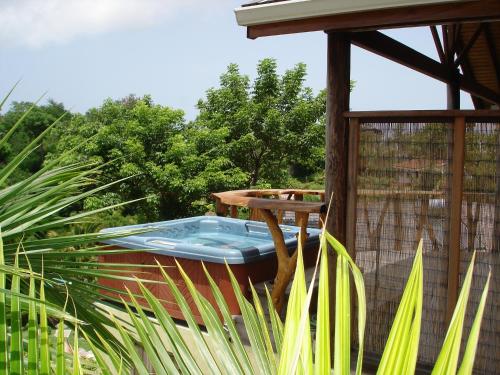 a hot tub sitting on a table in a garden at Maca Bana in Saint Georgeʼs