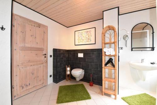 a bathroom with a toilet and a sink at Fewo Grohlz in Boos