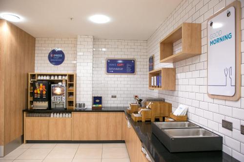 a restaurant kitchen with a counter and a sink at Holiday Inn Express Hull City Centre by IHG in Hull