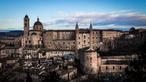 a large building with a tower on top of it at Castello Montegiove in Fano