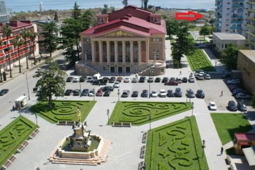 a large building with a fountain in a courtyard at John Apartment Old Batumi in Batumi