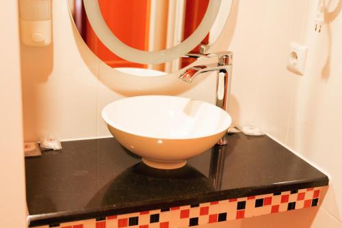 a bathroom with a sink and a mirror at Fontush Boutique Hotel in Ivano-Frankivsʼk