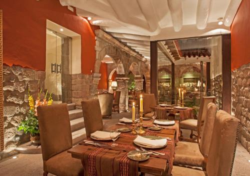 a dining room with a long table and chairs at Inkaterra La Casona Relais & Chateaux in Cusco