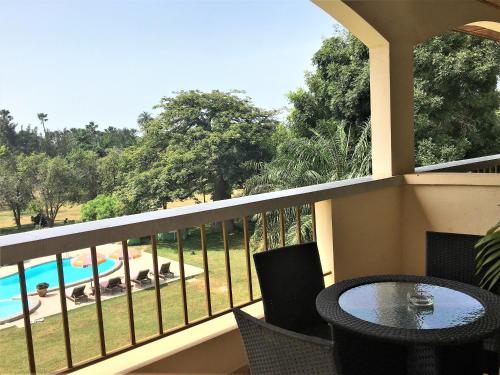 a balcony with a table and a view of a pool at Kololi Beach Resort in Kololi