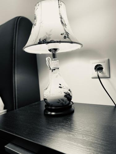 a black and white lamp sitting on a table at Central Square Apartment 2 in Pýrgos
