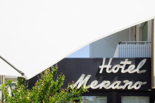 a sign for a hotel mecca in front of a building at Hotel Merano in Grado