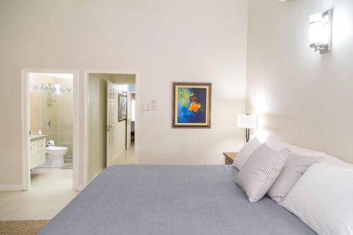 a white bedroom with a bed and a bathroom at Choose To Be Happy at Surbiton Square - Two Bedroom Townhouse in Kingston