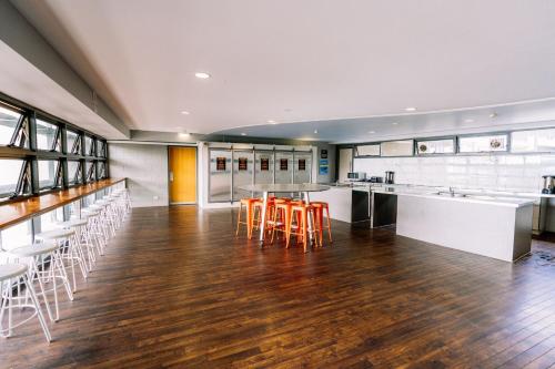 a large kitchen with a table and chairs at Gilligan's Hotel & Resort Cairns in Cairns