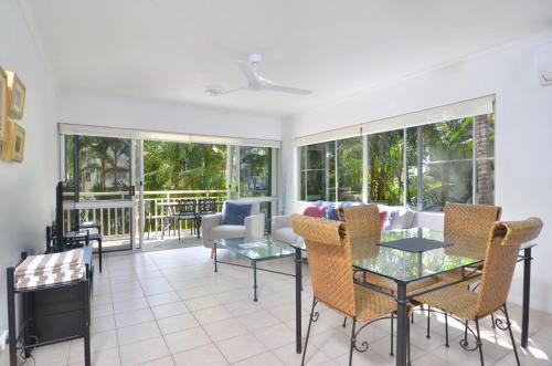 a living room with a table and chairs at Seascape Holidays - Driftwood Mantaray in Port Douglas