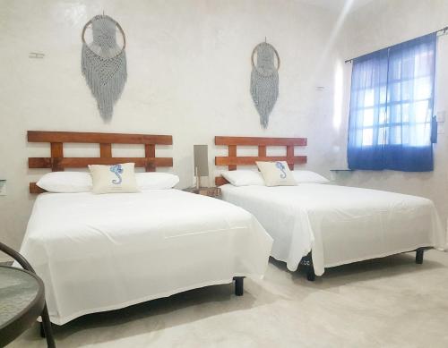 - une chambre avec 2 lits avec des draps blancs et une fenêtre dans l'établissement Casa Chujuk by Spirit Group, à Holbox