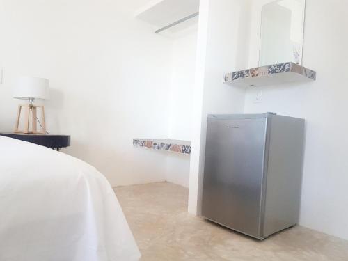 a white refrigerator sitting next to a white sink at Casa Chujuk by Spirit Group in Holbox Island