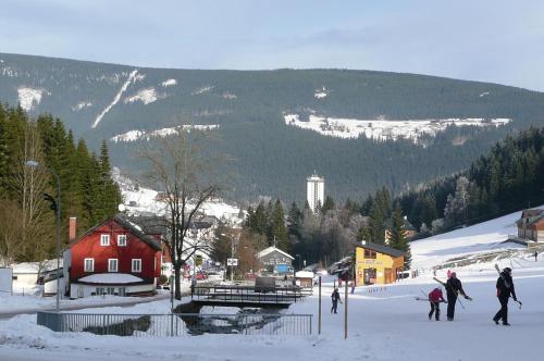 a group of people on skis in the snow at Apartmány Pod Javorem in Pec pod Sněžkou