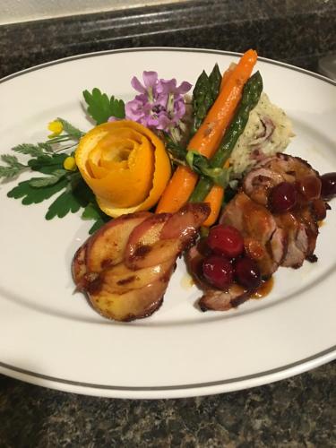 a white plate of food with meat and vegetables at Henderson Castle Inn in Kalamazoo