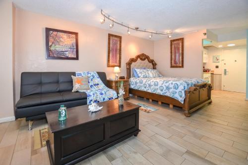 a living room with a bed and a couch at Daytona Beach studio condo with beautiful Ocean view in Daytona Beach