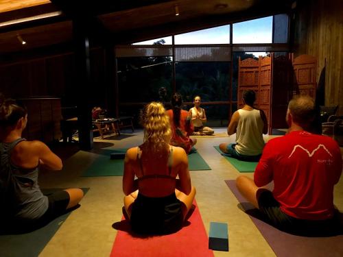 a group of people sitting in a yoga class at Pousada do Vale in Fernando de Noronha