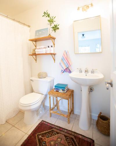 a bathroom with a toilet and a sink at RubyJune Inn in White Salmon
