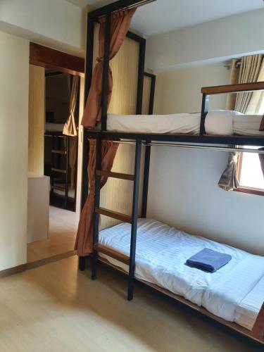 a room with two bunk beds in a hostel at Chada Mantra Hotel in Chiang Mai