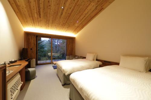 Un pat sau paturi într-o cameră la Regina Resort Kyukaruizawa