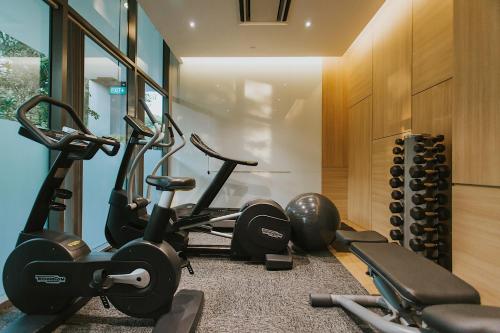 a gym with several exercise bikes in a room at Hotel Traveltine in Singapore