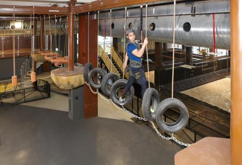 a man is climbing on tyres in a gym at Discovery Hotel in Magong